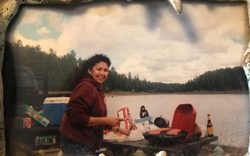 Women smiling at camera, lake in background